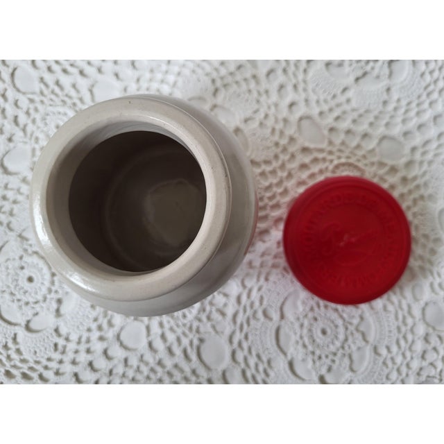 A ceramic French mustard jar or crock, labeled 'Moutarde De Meaux Pommery'. It measures 5 ¼” h x 4” base x 3” at lid. A...