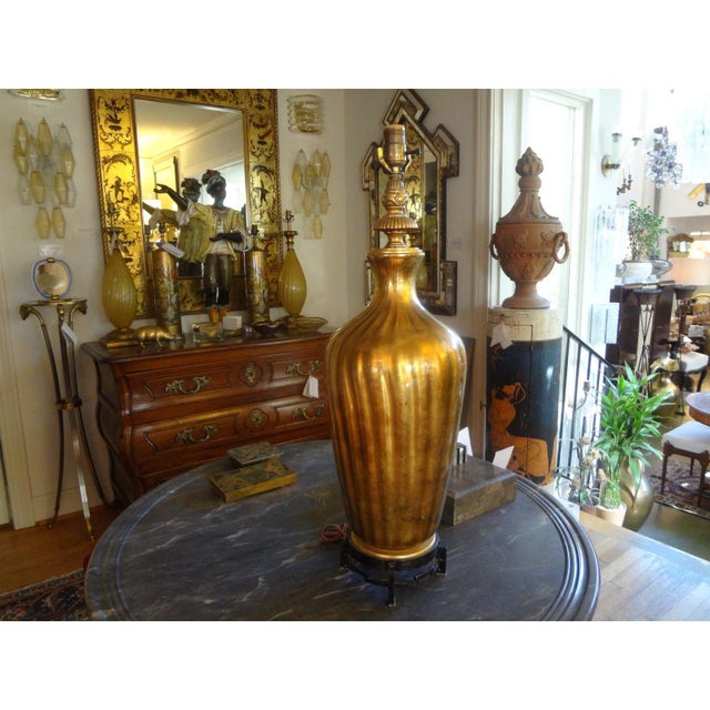 Large-scale Italian mid-century gold blown glass on interesting Asian modern iron base . This stunning Hollywood Regency...