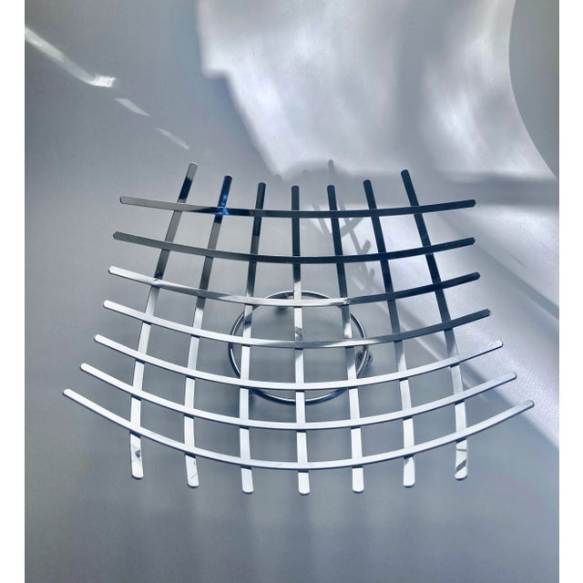 Modern sculpted Chrome Arched Woven Criss Cross footed Fruit Basket. Featuring a curved concave square reflective Chrome...