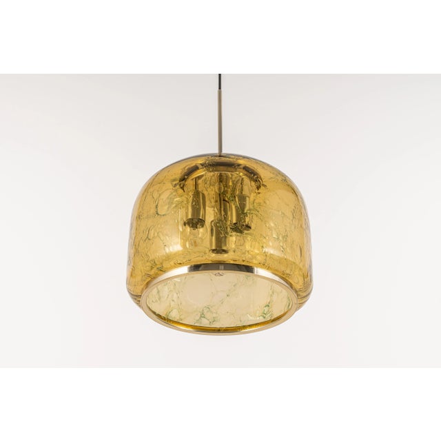 Doria pendant light with large volcanic murano glass ball. High-quality materials give a wonderful light effect when it is...