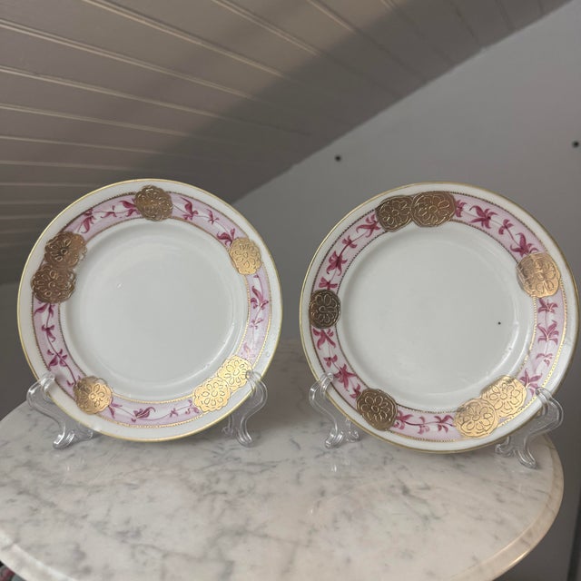 A matching pair of early 20th-century Japanese porcelain cabinet or dessert plates hand-painted by Noritake. The plates...