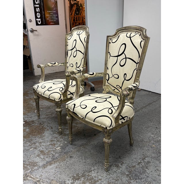 Design Plus Gallery presents a Pair of French Neoclassical Armchairs from the 1930's. The pair showcases tall shaped...