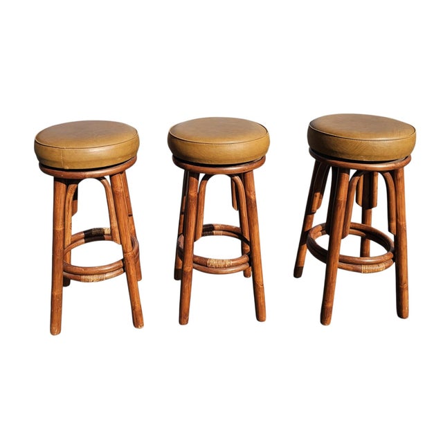 A rare find in this condition, this exceptional set of four mid-century modern stools remains fully intact and beautifully...
