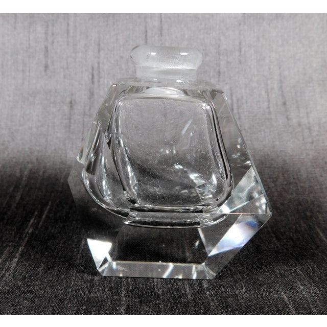This is a smaller cut crystal perfume bottle with a cut crystal stopper. The bottle is made of flat cut panels and does...