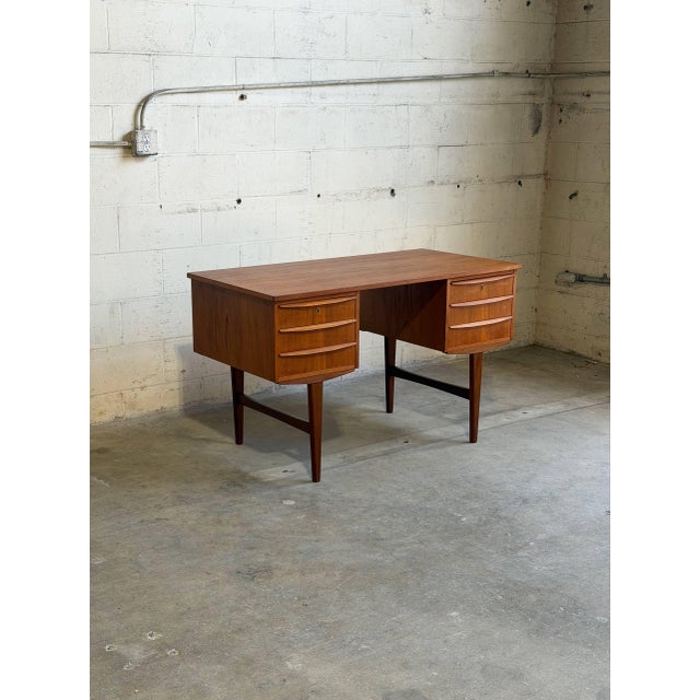 Danish Mid-Century Modern executive desk crafted in warm teak, featuring clean Scandinavian lines and elegant organic...