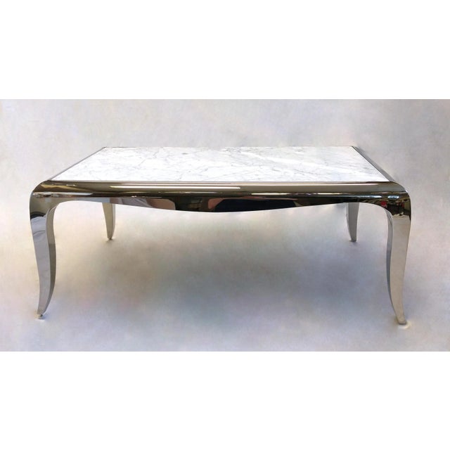 From Caracole, this stunning cocktail table features a solid white marble top with natural grey veining set against a...
