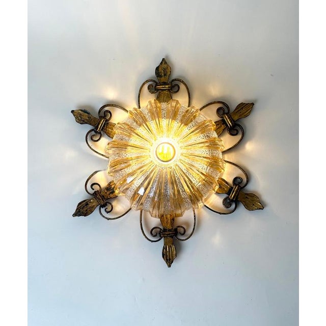 Decorative german flush-mount ceiling light dating from the 1970s. The fixture features an ornate wrought-iron frame with...
