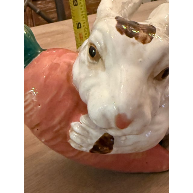 Cute bunny rabbit holding on to a large carrot. Majolica style bunny looks like he’s holding on for dear life. He would be...