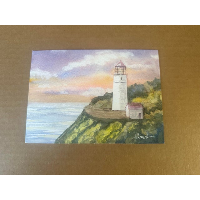 Original artwork, one of a kind. Signed by the artist. A peaceful coastal scene featuring a lighthouse perched above the...
