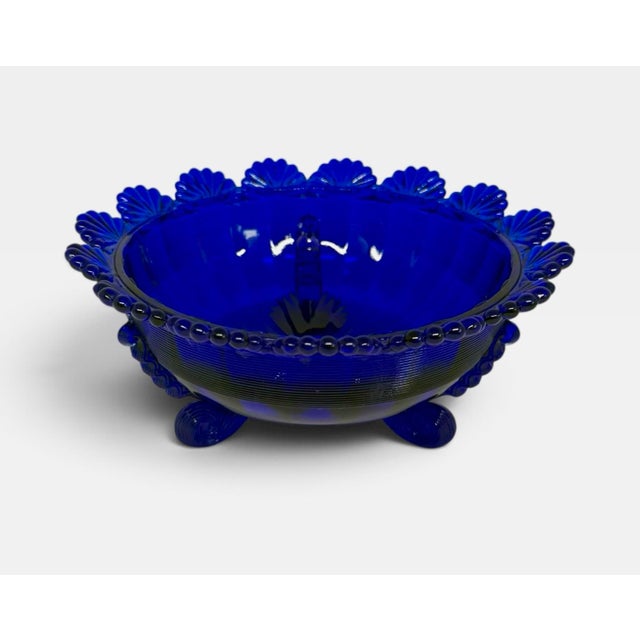 Elevate your tablescape with this stunning 1980’s Mosser Glass footed centerpiece fruit bowl in a striking, rich Cobalt...