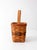A 1992 Longaberger handwoven basket in warm honey-toned wood with woven red and green accent bands along the rim. The tall...