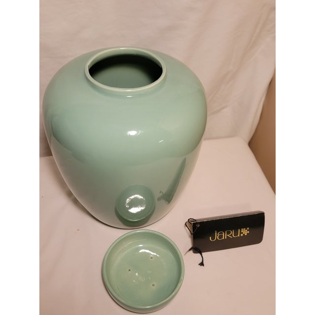 This vintage 1981 Jaru California Pottery ceramic vase features a smooth, glossy sage green or celadon glaze and an...
