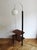 A rare and elegant modernist floor lamp featuring a glass globe lampshade and two integrated low-level shelves, preserved...