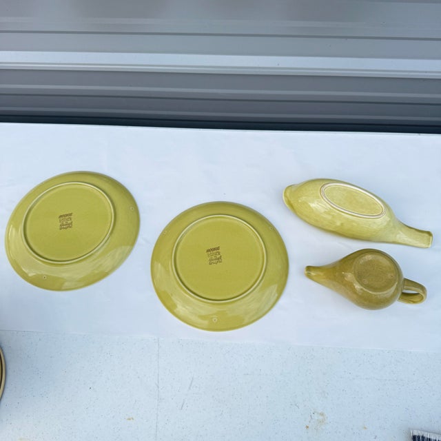 Four piece set of dinnerware from Russel Wright’s Iroquois line. They are all the same chartreuse color, no chips or...