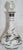 Three leaf clovers in silver surround this lovely bottle made of clear over opal cased glass. It is topped with a clear...
