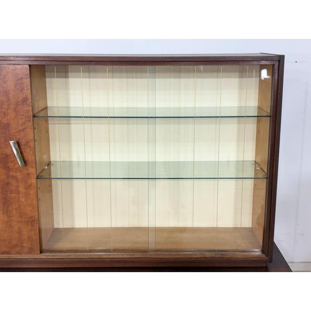 Beautiful vintage sideboard from the 1960s in good, used condition. The piece is constructed in two parts and impresses...