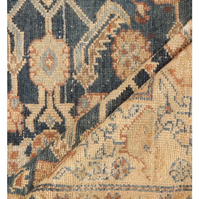 A lovely antique Malayer handwoven rug with blues and an abrash in soft gray. Abrash is a natural change in color that...