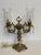 The design of this double-armed Hollywood Regency candelabra crystal table lamp is from the mid-20th century, around the...