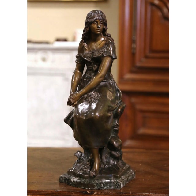 This elegant figure composition was crafted in France circa 1880. Built of spelter, the statue stands on a shaped black...