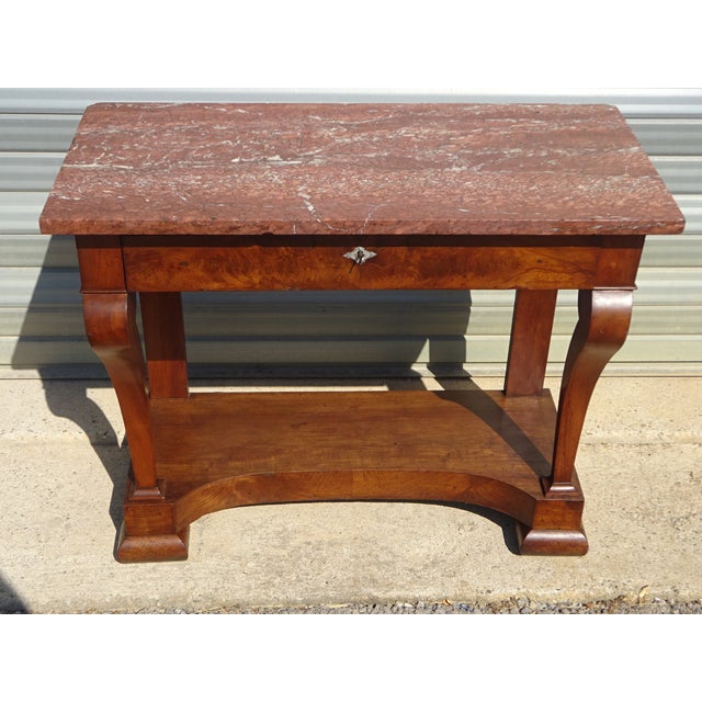 Superb french-made console table in solid walnut and walnut veneer, typical of the charles x style. a large drawer in the...