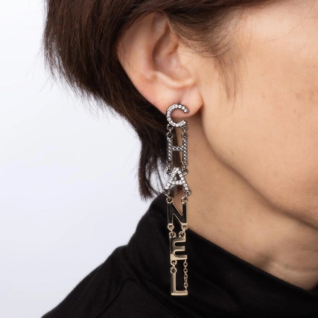 Estate Chanel Chanel crystal long drop earrings (circa 2020) crafted in yellow gold tone and blackened gold tone. Crystals...