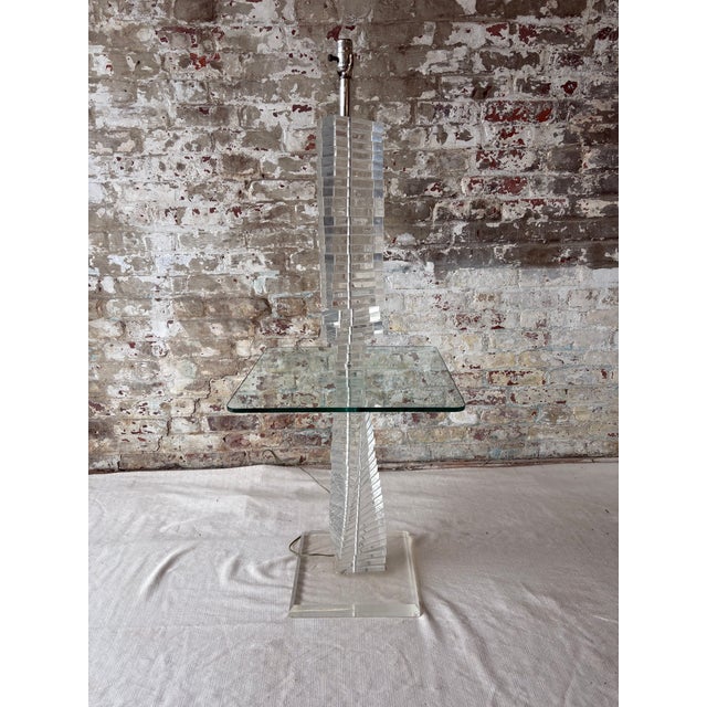 Exceptional vintage lucite floor lamp featuring a sculptural stacked acrylic column and integrated square glass side table...