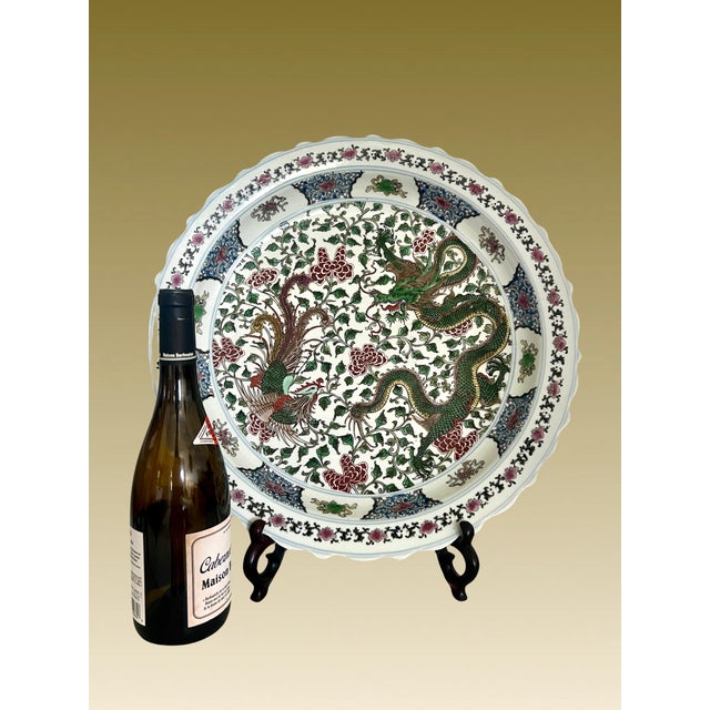 Massive 18" Chinese enamelled porcelain dragon and phoenix charger, a five colour charger, white glazed ground. The...