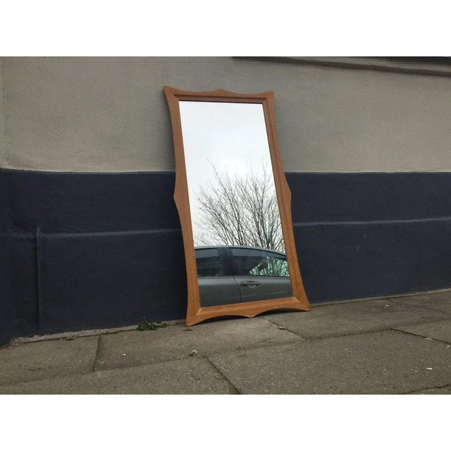 - Curvy and sculptural wall mirror with oak solid frame - Numbered 353 and carries a 'Made in Denmark' burn-mark on the...