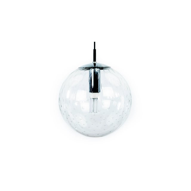 Glass globe pendant light by Raak Amsterdam. The light comes with a metal suspension. This piece has an attribution mark,...