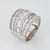Stylish wide diamond band crafted in 18 karat white gold (circa 1970s). Mixed cut round brilliant and baguette diamonds...