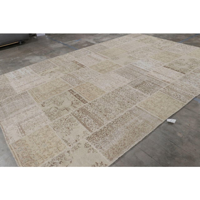 Handwoven in wool and originating from Turkey circa 1980-90, this 10x14 vintage patchwork rug is a new by Rug & Kilim. On...