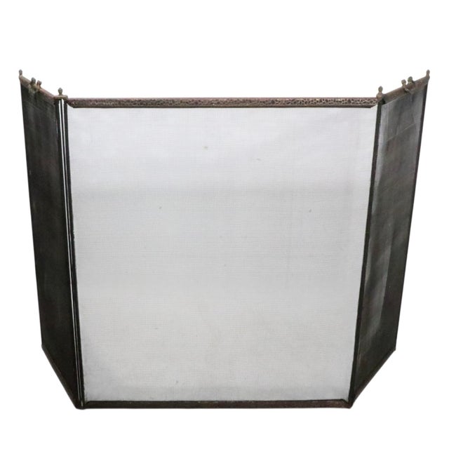 Vintage folding fireplace screen, spark guard, having three panels, with swing handles at the top of the two side panels....