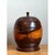 This vintage turned wood lidded vessel is a study in warm, sculptural craftsmanship. Its plump, globular body swells...
