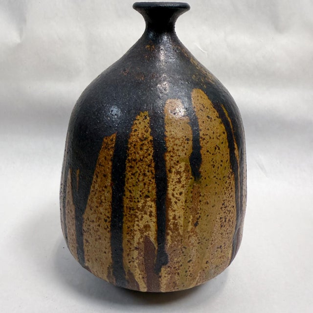 For your consideration, a mid-century modern sculptural pottery vase with earth tones. Signed at the bottom, unable to...