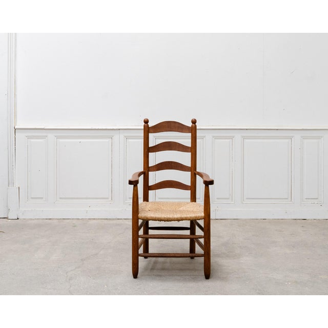 A very elegant oak and straw armchair from the 1950s, reminiscent of Charlotte Perriand's furniture. We love its simple...