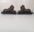 A pair of bronze mirror image lions on Belgian slate bases with small ball feet.