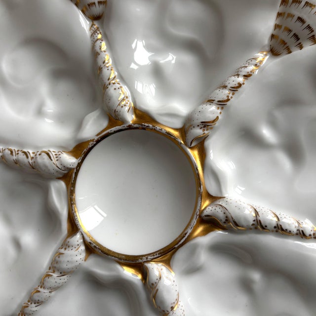 Showcase elegant coastal charm with this stunning antique oyster plate, dating to circa 1880–1910. This piece features six...