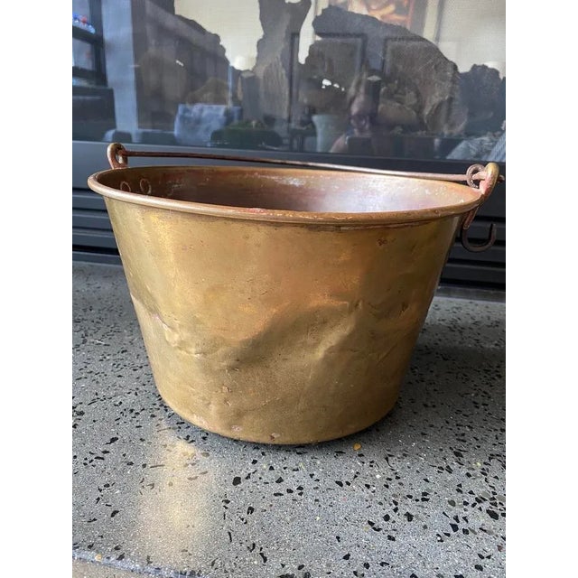 An antique brass pail or bucket that has seen it's share of work since the 1800's. The very-much used pail with some...
