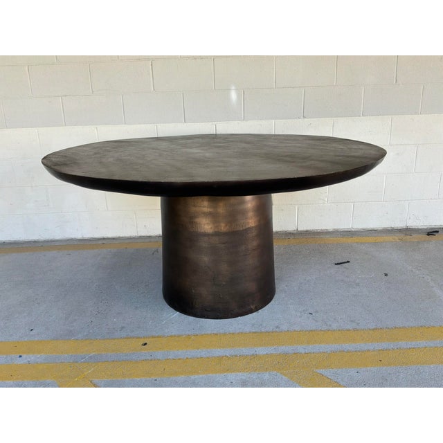 Stylish Uttermost Madrone Outdoor / Indoor Metal Dining Table. Sculptural cylindrical pedestal base, textured dark bronze...