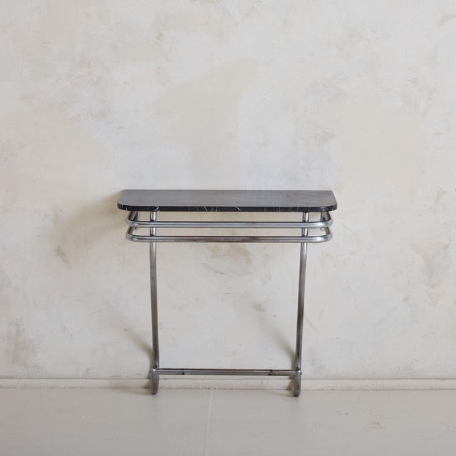 Sold and priced individually. This console table features a streamlined Art Deco design, characterized by its sleek,...