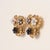14K Yellow Gold | Circa 1960s A graceful example of mid-century elegance, these vintage floral clip-on earrings combine...