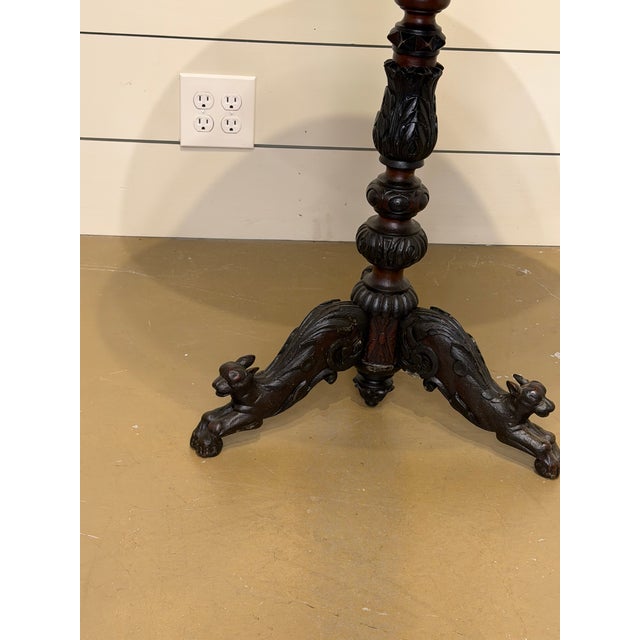 This is an lovely Black Forest antique side table! The rich ebony colors of the wood base blend together with the warm...