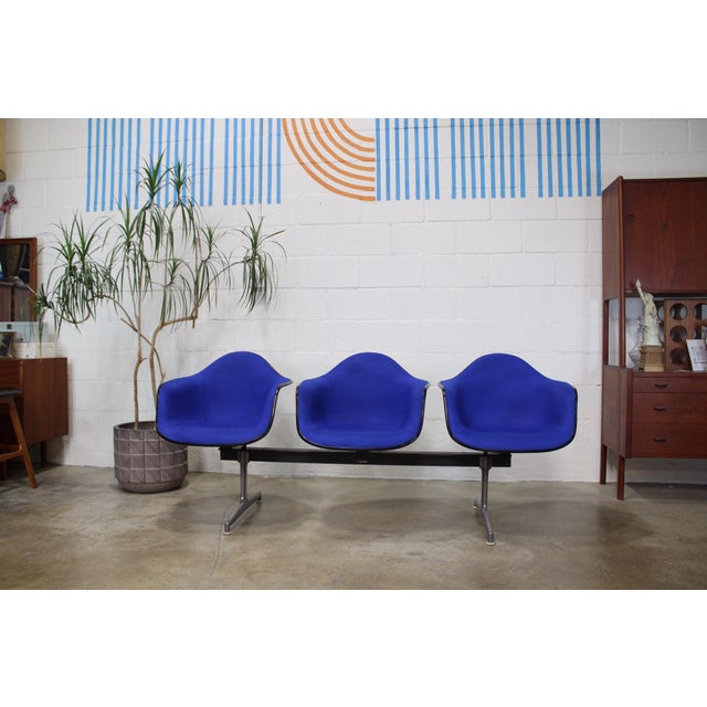 3 upholstered Herman Miller fiberglass shells with Alexander Girard upholstery on an original Herman Miller Tandem Bench....