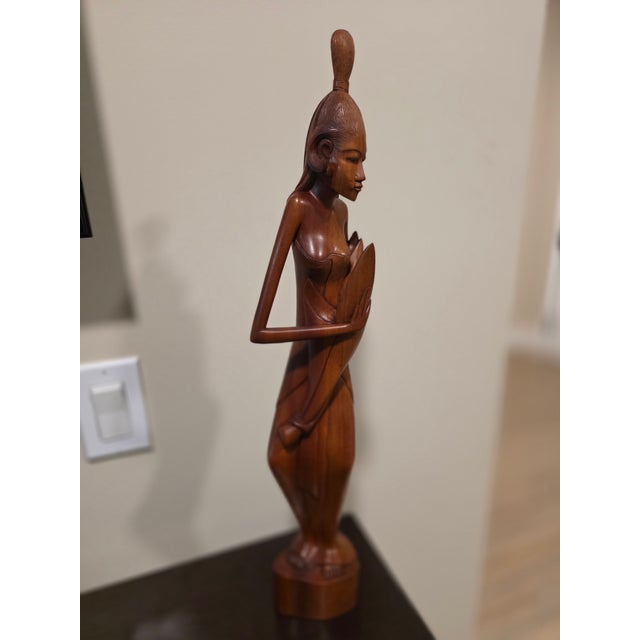Overview A commanding, museum-grade Mid-Century Balinese modernist figurative sculpture standing at an imposing 21 inches....