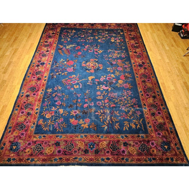 A striking example of early 20th-century oversize Chinese Art Deco rug in an allover floral pattern. Hand-knotted with...