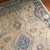 A refined contemporary Oushak, this hand-knotted Turkish rug features a soft beige field layered with light and deep blue...