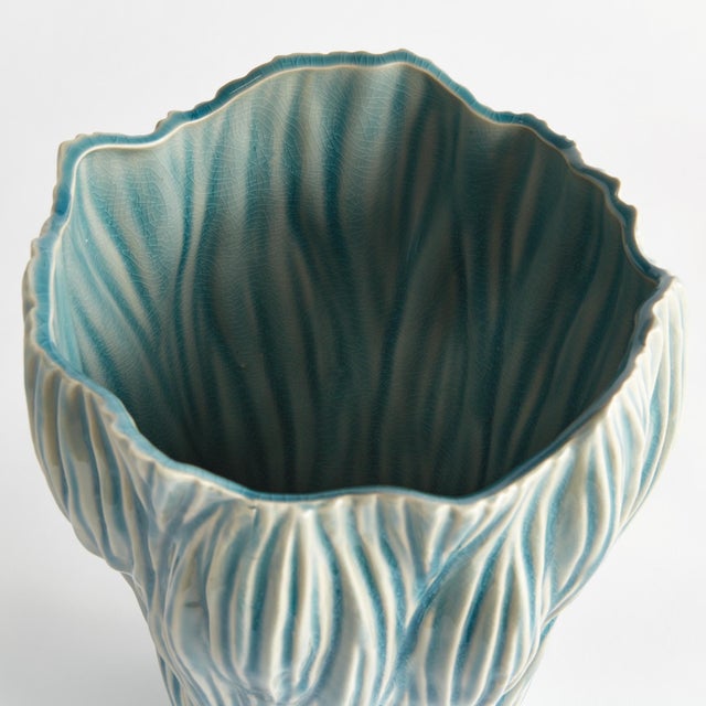 This artisanmade ceramic vase is a real beauty. The reactive glaze accentuates the natureinspired texture of the piece. A...