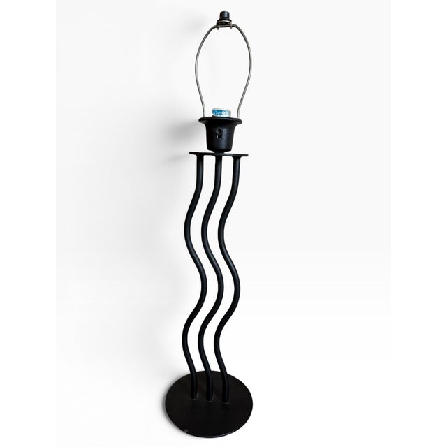 Striking vintage Cresswell table lamp featuring three sculptural, undulating black metal columns rising from a substantial...