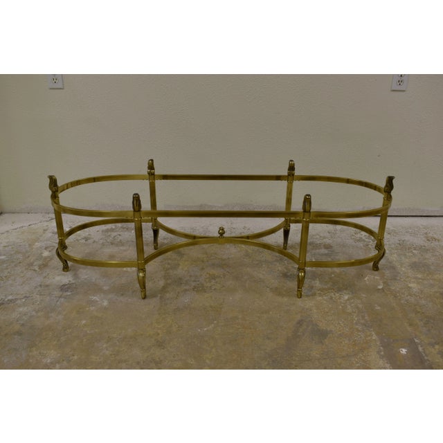 La Barge Neoclassical coffee table features a brass frame with a beveled glass top, designed in a Neoclassical or...