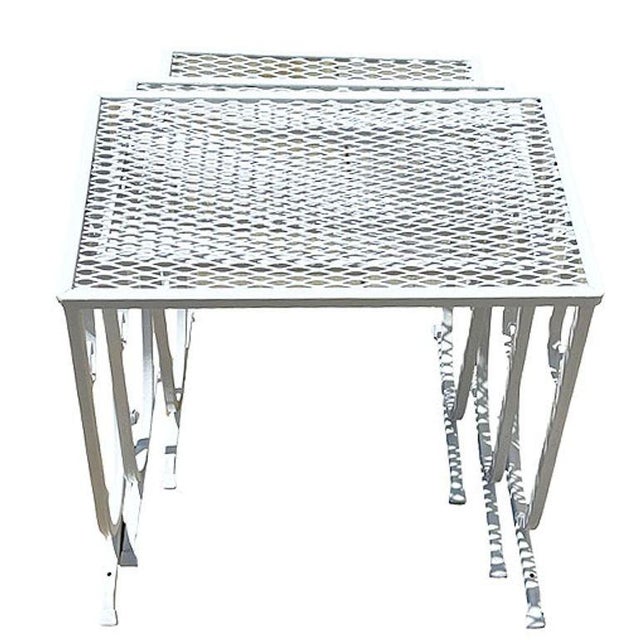 Set of three Mid-Century Modern wrought iron nesting tables in the style of Salterini. Each table features a welded...